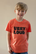 Child wearing an orange t-shirt with 'VERY LOUD' text on a plain background