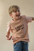 Child wearing a 'Cheeky Chimp' t-shirt against a plain background