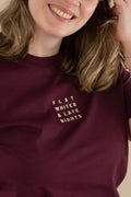 Person wearing a maroon sweatshirt with 'FLAT WHITES & LATE NIGHTS' text