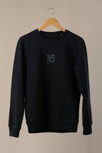 Black sweatshirt with 'Black Coffee Club' text on a beige background