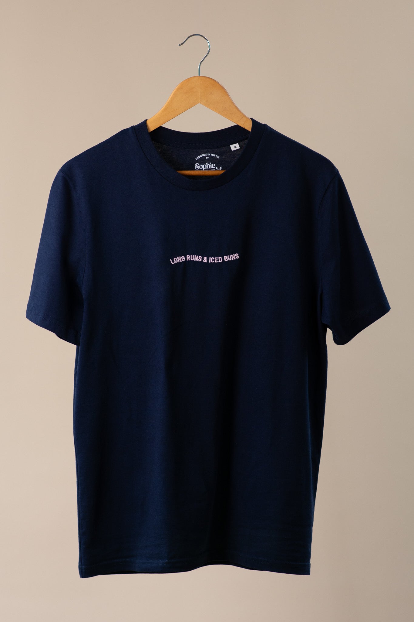 Navy blue t-shirt with text on a beige background