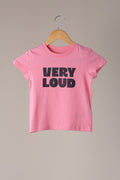 Pink t-shirt with 'VERY LOUD' text on a hanger against a beige background