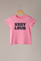 Pink t-shirt with 'VERY LOUD' text on a hanger against a beige background