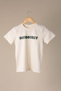 White t-shirt with 'OUTDOORSY' text on a hanger against a beige background