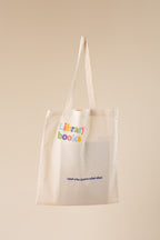 Beige tote bag with 'library books' text on a beige background
