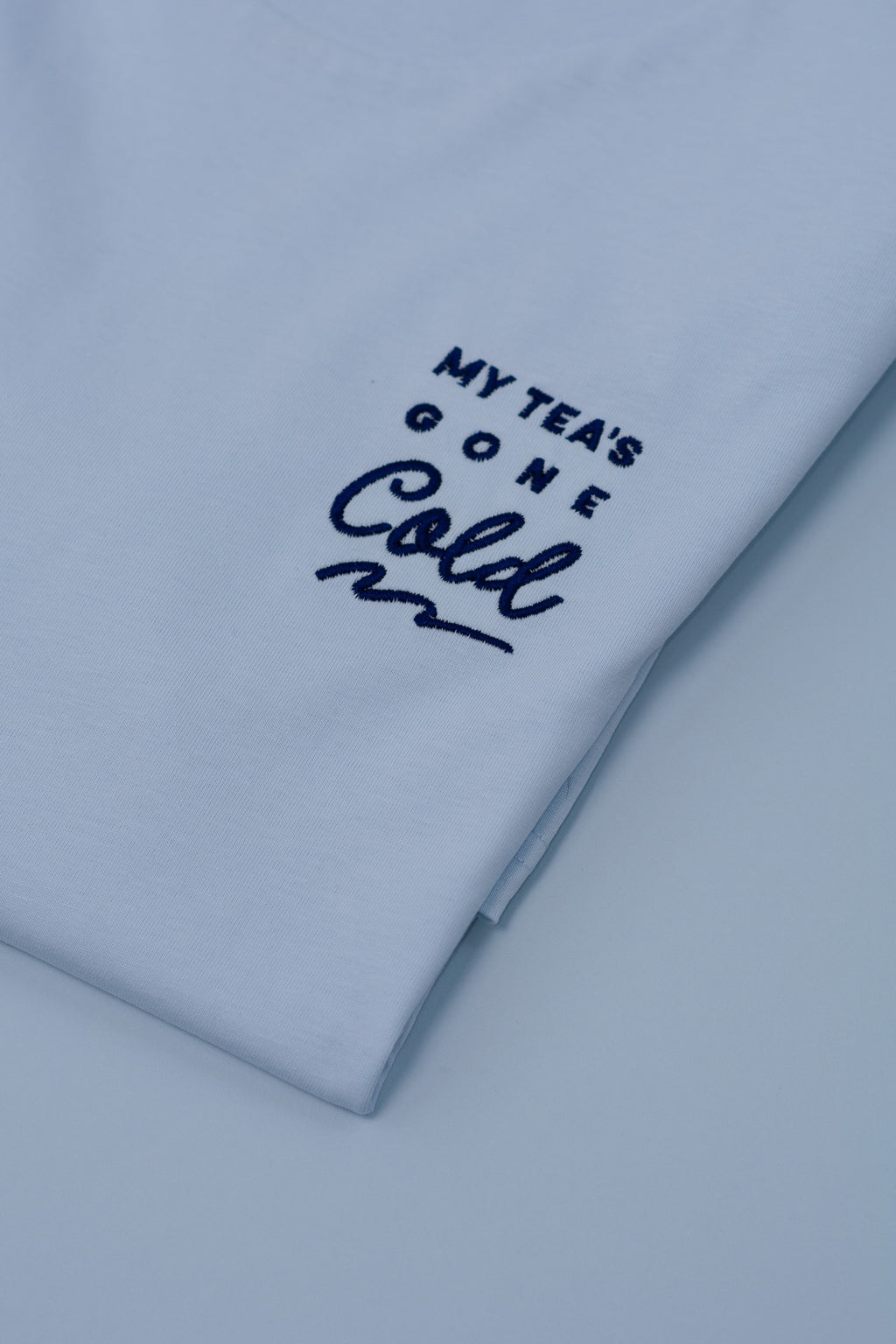 Light blue t-shirt with text 'My Tea's Gone Cold' on a white background