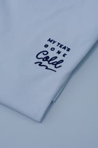 Light blue t-shirt with text 'My Tea's Gone Cold' on a white background