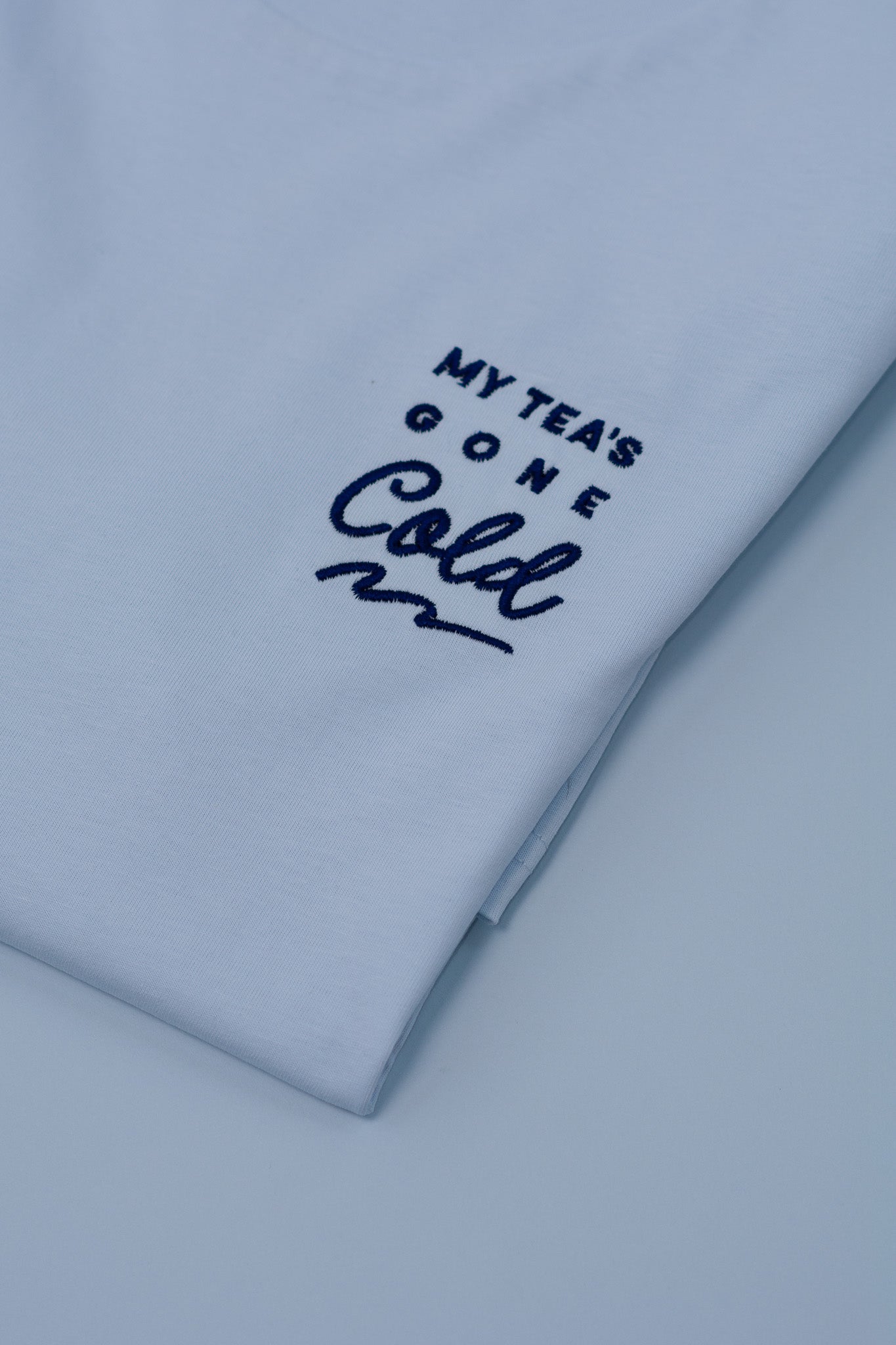 Light blue t-shirt with text 'My Tea's Gone Cold' on a white background