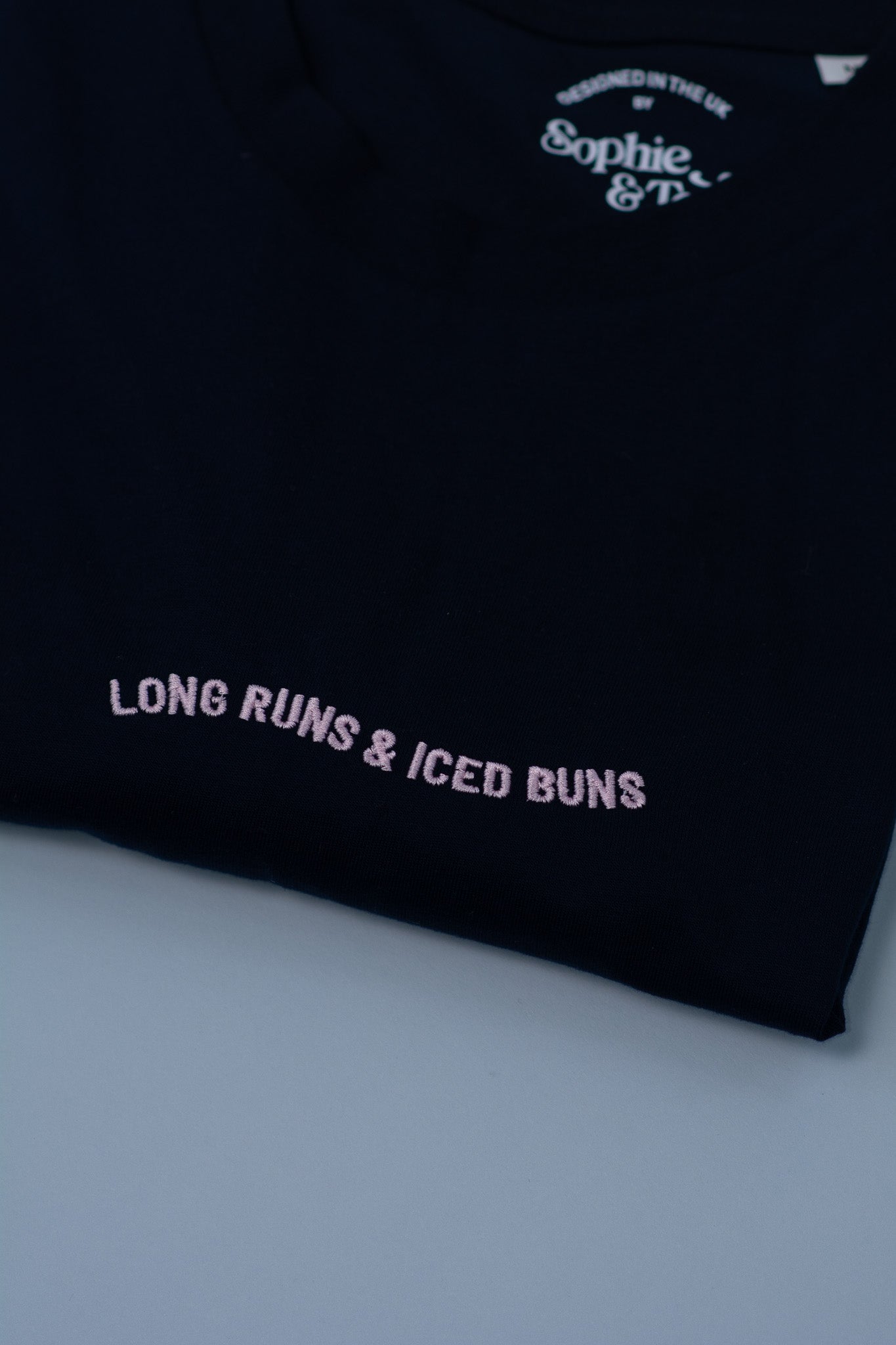 Navy t-shirt with text on a light grey background