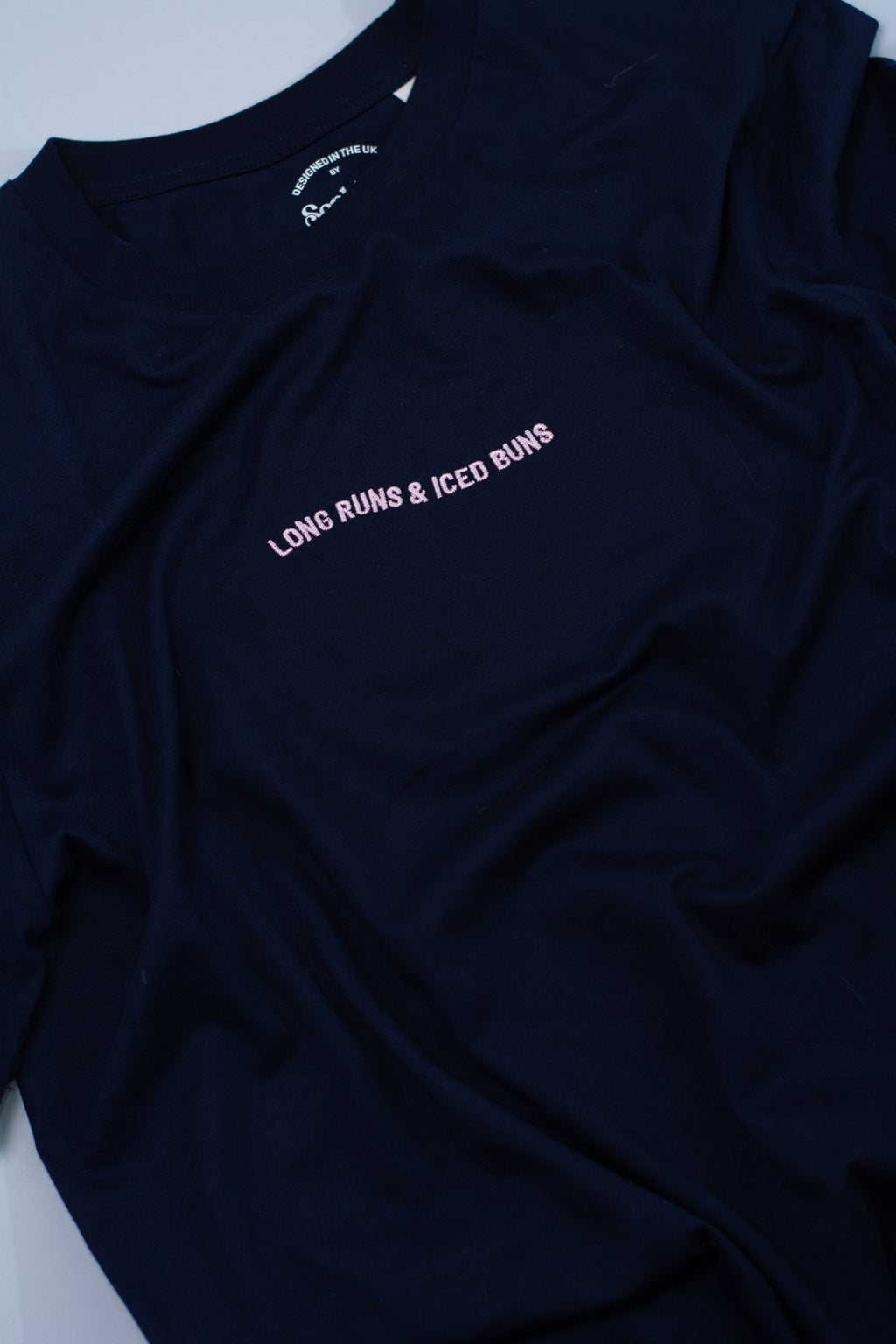 Navy blue t-shirt with text on a light grey background