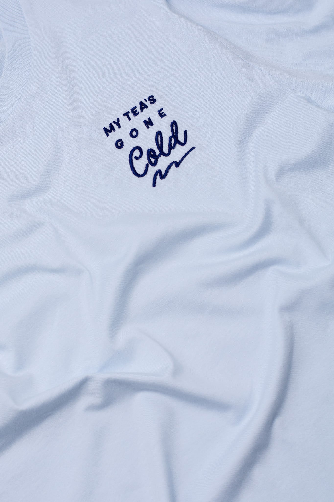 Light blue t-shirt with text 'My Tea's Gone Cold' on a white background