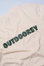 Beige t-shirt with 'OUTDOORSY' text on a light blue background