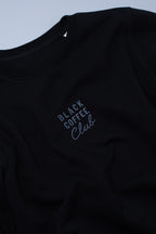 Black sweatshirt with 'Black Coffee Club' text on a light blue background