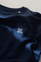 Navy blue sweatshirt with 'Rain or Shine' text on a light gray background