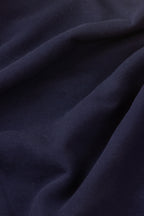 Close-up of dark blue fabric with folds