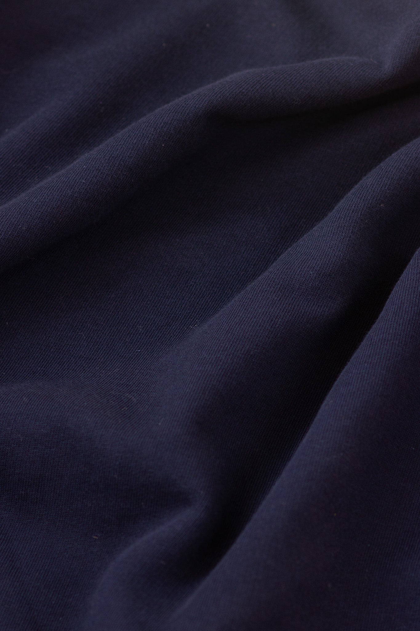 Close-up of dark blue fabric with folds