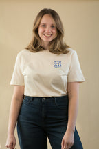 Woman wearing a white t-shirt with blue text against a beige background