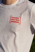 White t-shirt with red text 'GENERAL POST-RUN SMUGNESS' on a blurred natural background
