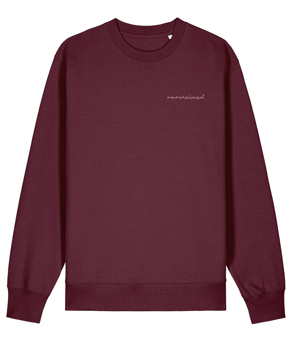 Maroon sweatshirt with 'unravelled' text on a white background